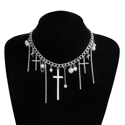 Necklace with cross and pearl pendants on a black mannequin bust.