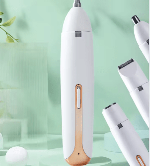 White electronic device with gold accent on a light green background Hair trimmer