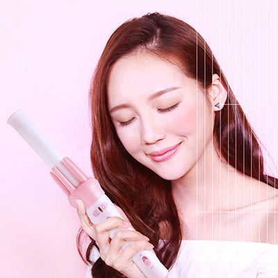 Woman holding a hair straightener with a pink background hair beauty comb brush
